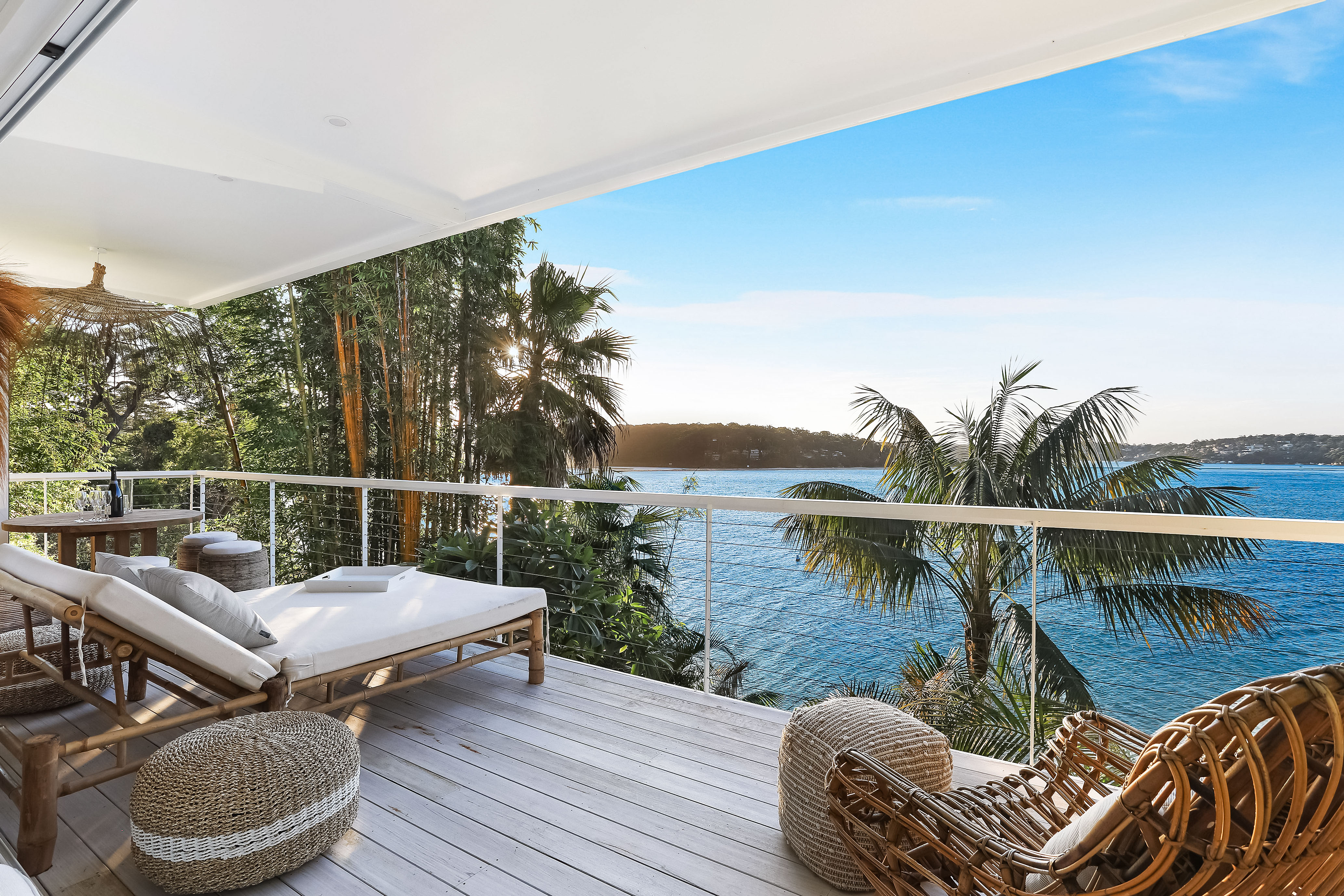 Bundeena Sands waterfront deck with rattan loungers overlooking the bay